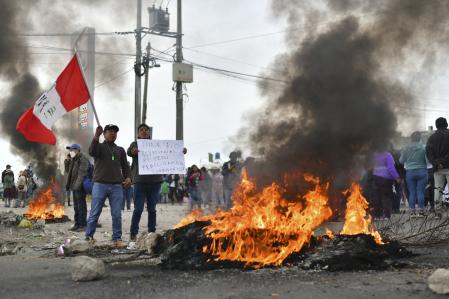 Protesters take the Pan-American highway in the Northern Cone of Arequipa after the announcement by the new Peruvian president Dina Boluarte of her intention to present a bill to parliament to advance the scheduled general elections